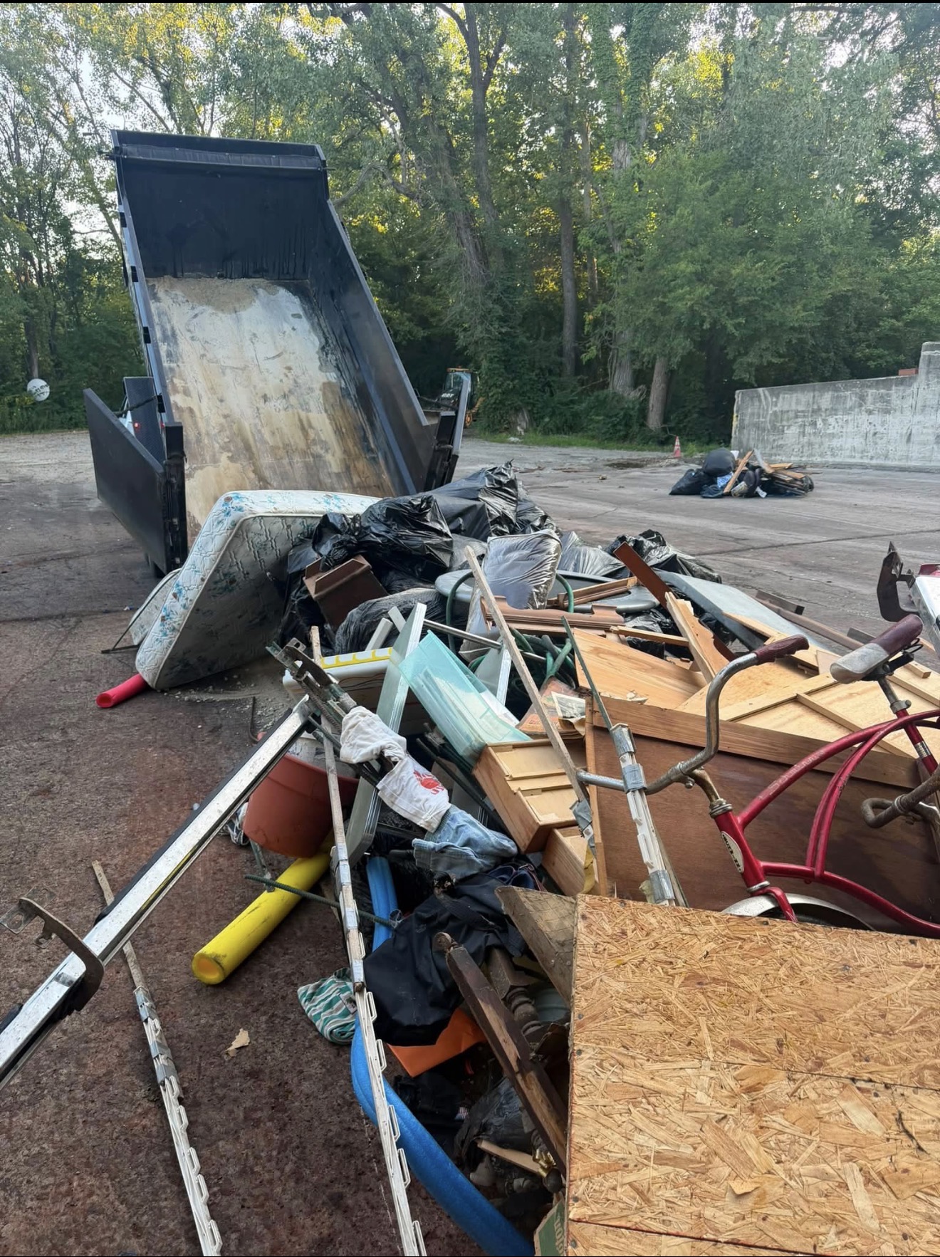 Dump trailer unloading debris from a property cleanout